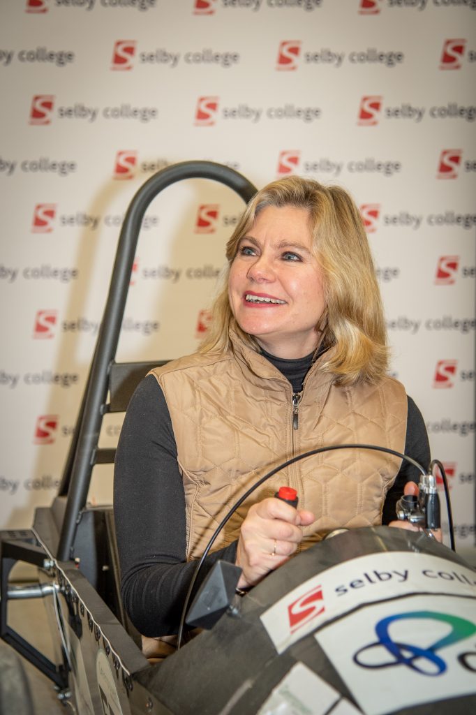 Close up of Justine Greening in the electric vehicle.