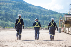 Drax workers in PPE walking at pellet mill