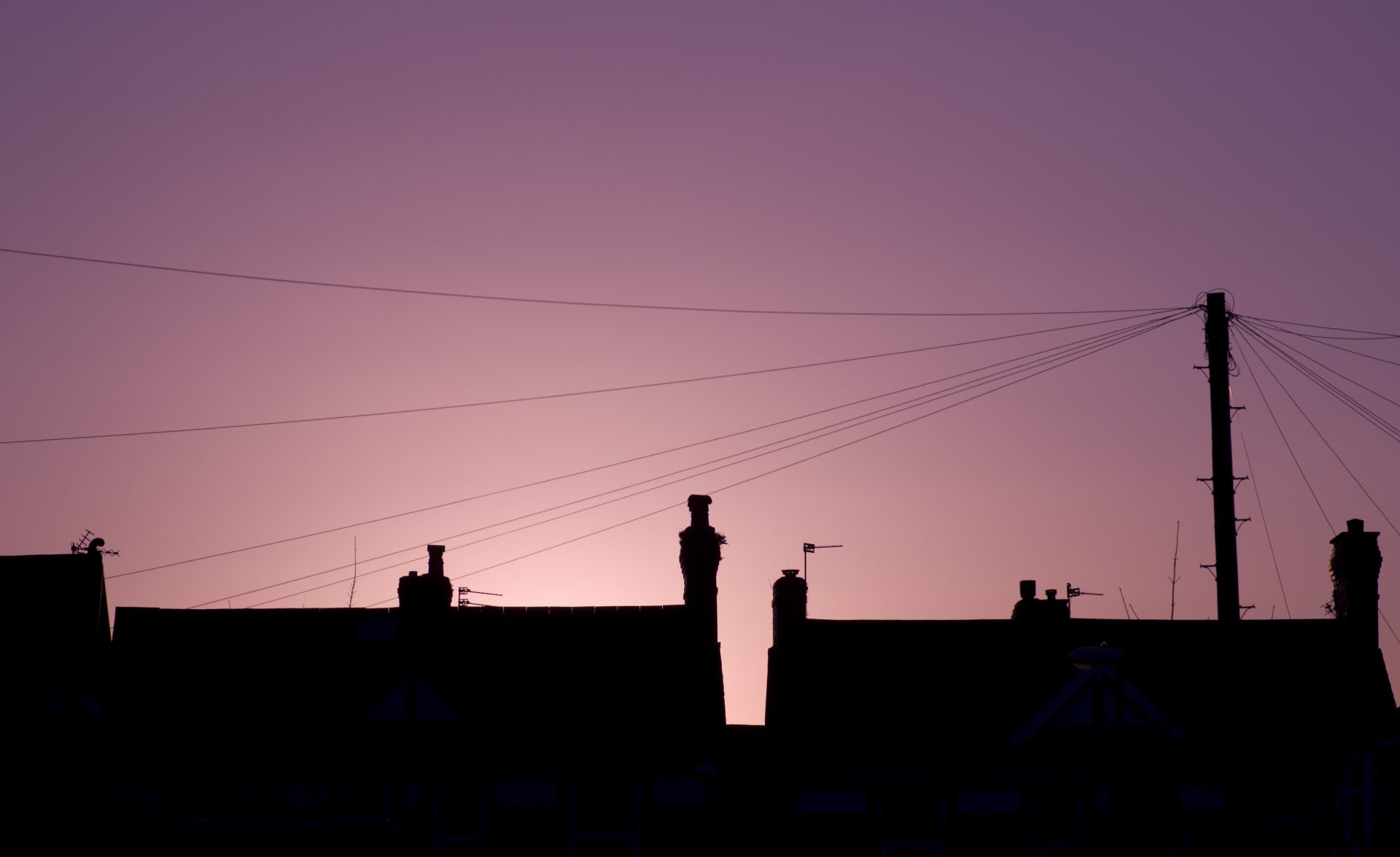 Houses in front of electricity pylons