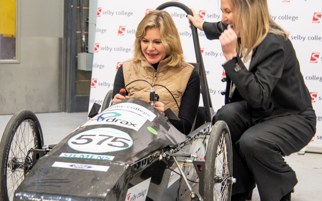 Justine Greening at Selby College in electric car