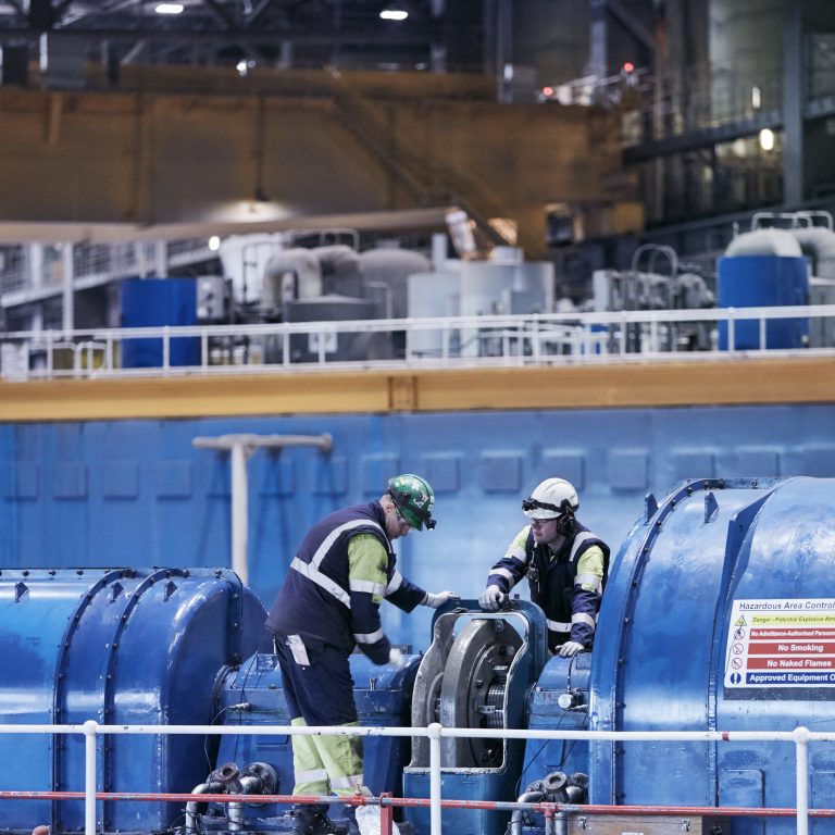Engineers inspect generator in Drax Power Station turbine hall, 2019