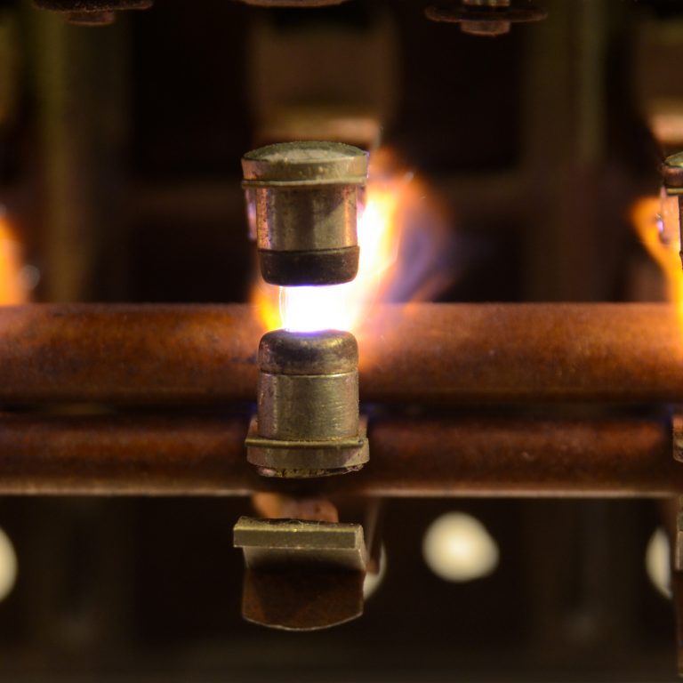 Electric relay with sparks jumping between the contacts doe to breaking a heavy inductive load.