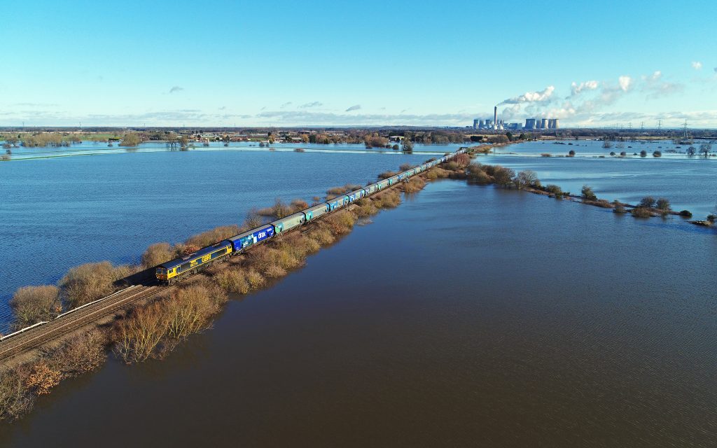 A GBRf biomass train makes its way from Drax Power Station after February floods. By Chris Davis