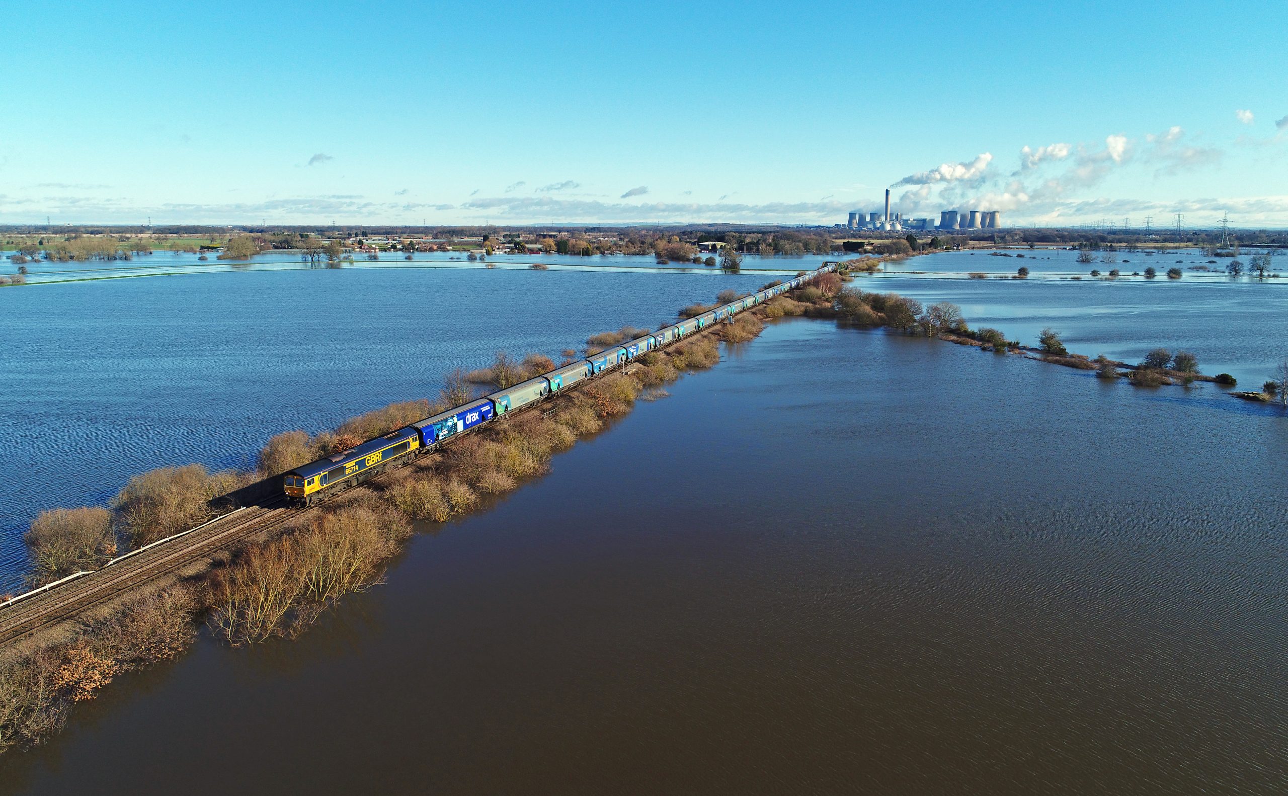 A GBRf biomass train makes its way from Drax Power Station after February floods. By Chris Davis