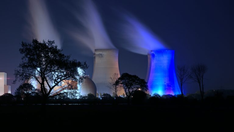 Drax Power Station cooling tower turned blue for the NHS and #ClapForCarers with biomass storage domes on left
