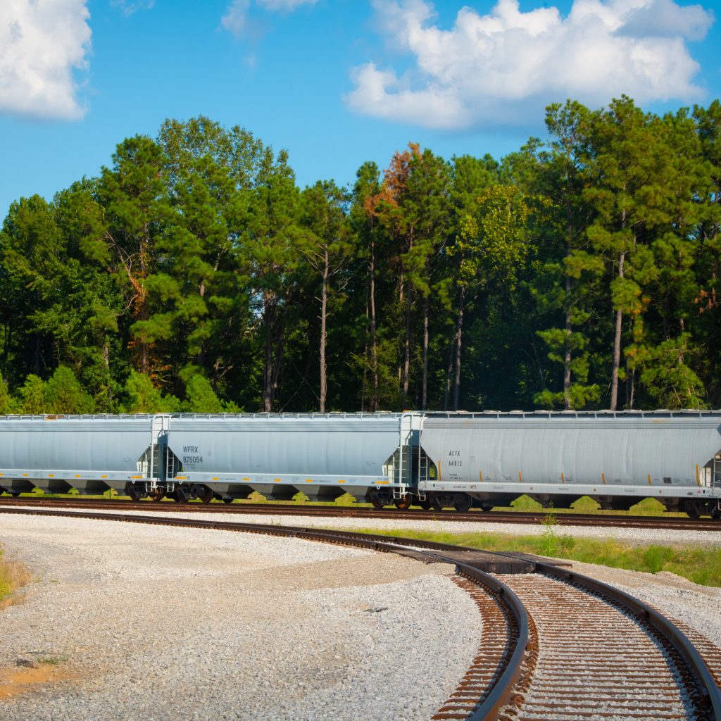 Drax Biomass railroad wagons and healthy forest at LaSalle BioEnergy sustainable biomass wood pellet plant in Louisiana.