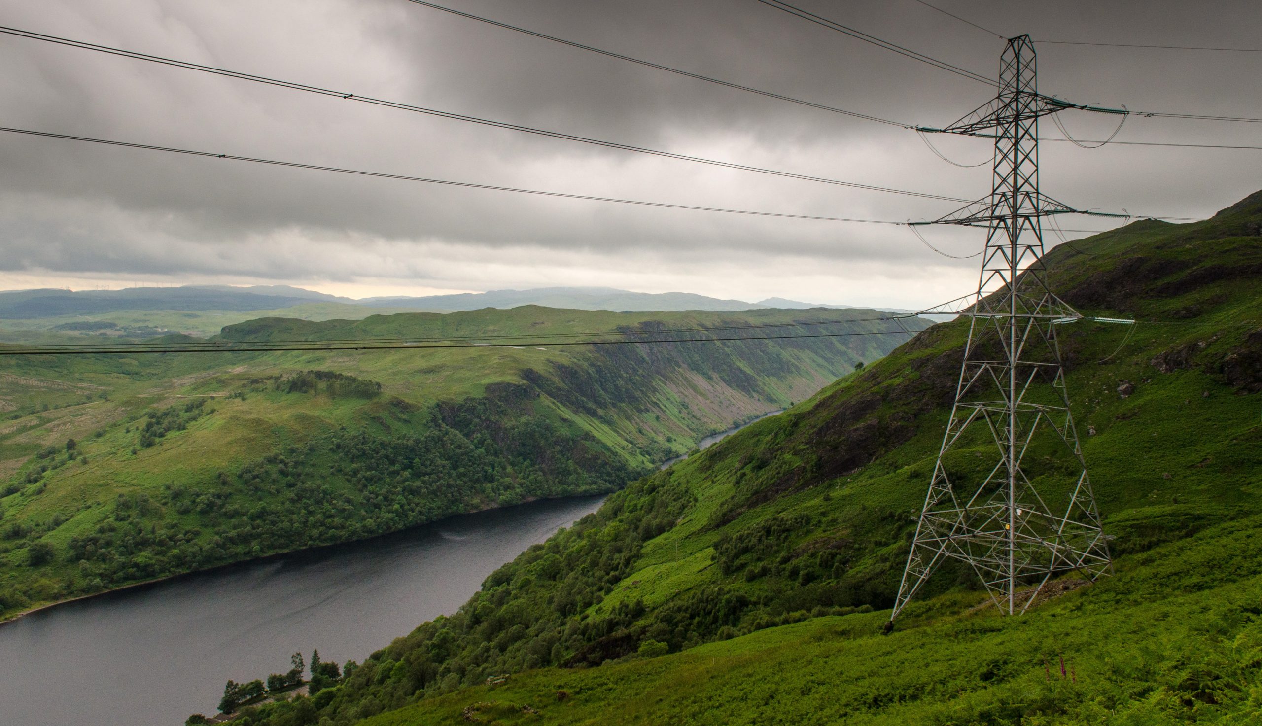 A pylon carries electricity transmission lines from Cruachan Hydroelectric Power Station above Loch Awe in the mountains of the West Highlands of Scotland