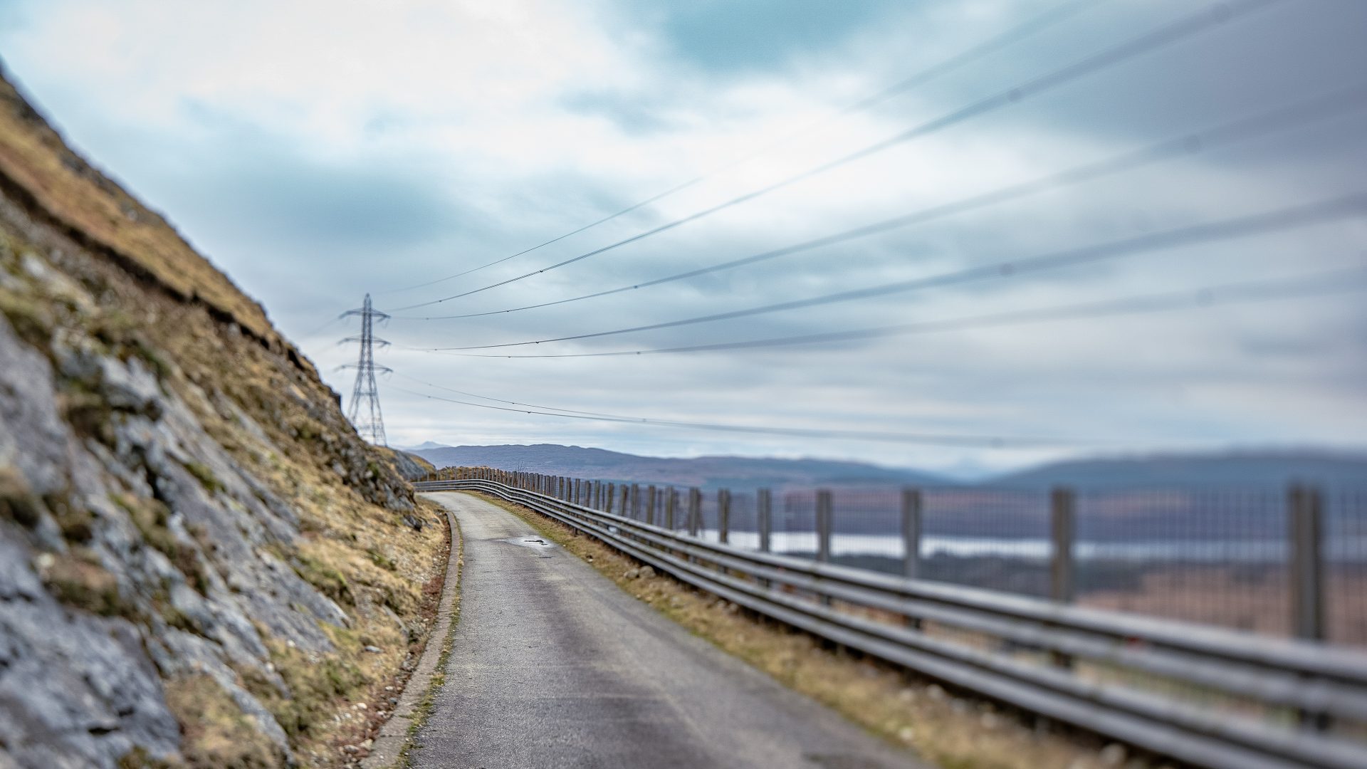 Electricity cables and pylon snaking around a mountain near Cruachan Power Station in the Highlands