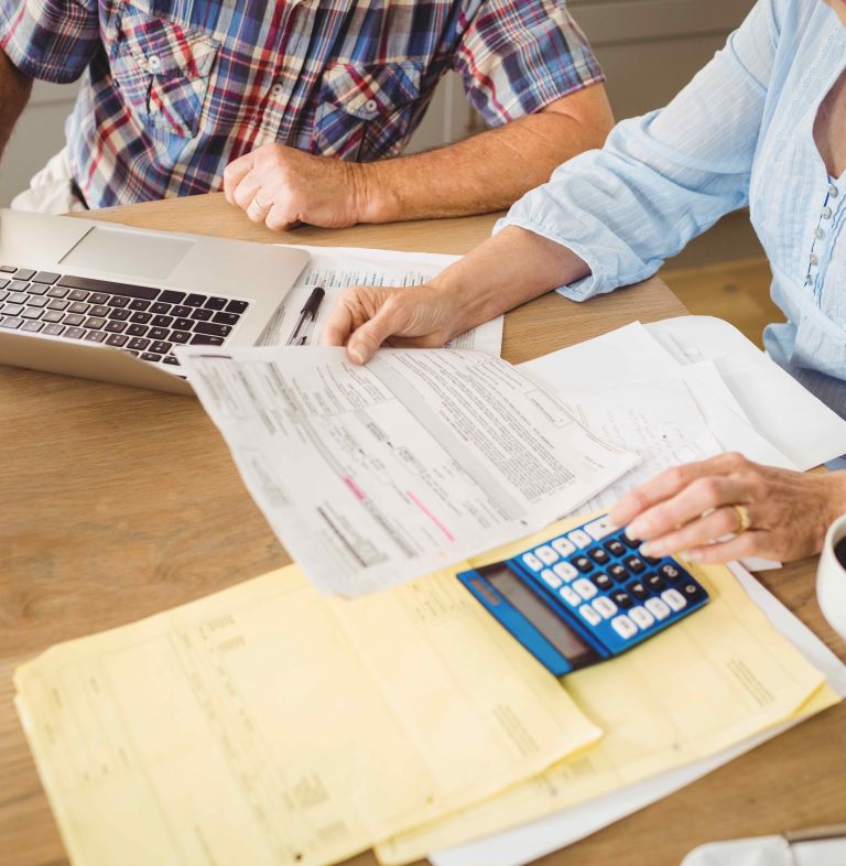 Senior couple checking their bills