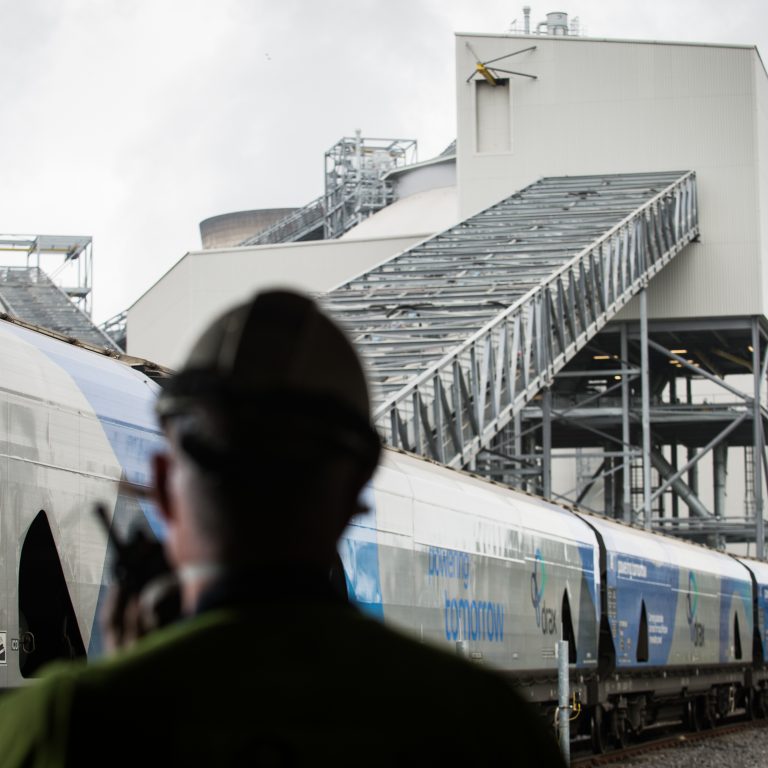 Man standing in front of train