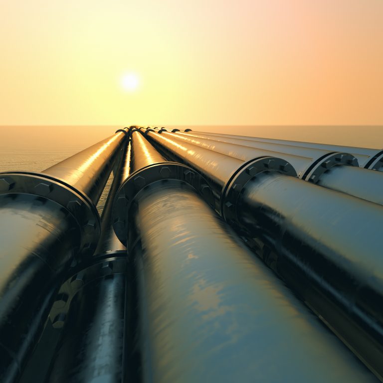 Tubes running in the direction of the setting sun. Pipeline transportation is most common way of transporting goods such as Oil, natural gas or water on long distances.