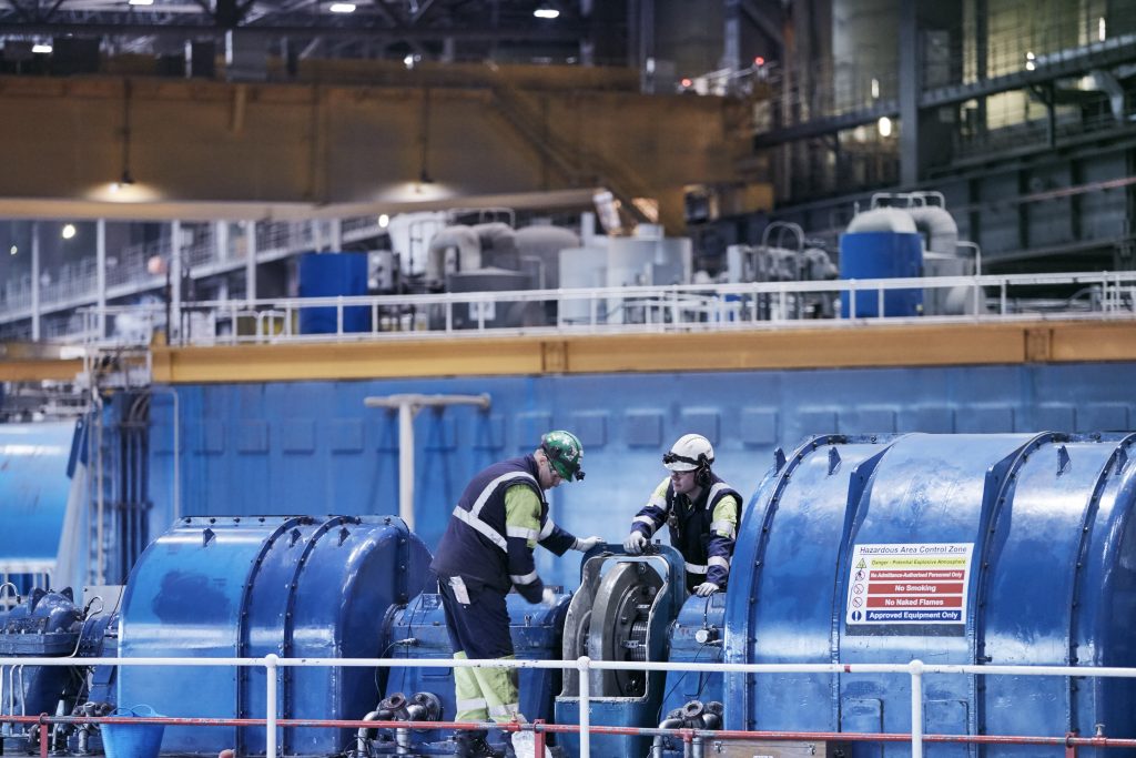 Engineers inspect generator in Drax Power Station turbine hall, 2019