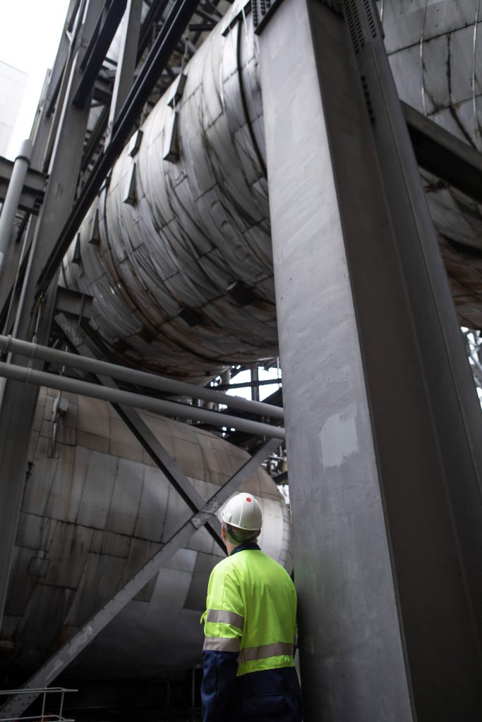 An engineer looks up at flue gas desulphurisation unit (FGD) at Drax Power Station. The massive pipe would transport flue gas from the Drax boilers to the carbon capture and storage (CCS) plant for CO2 removal of between 90-95%.