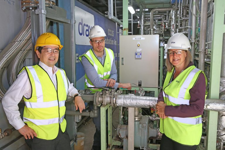 Pictured L-R: Kentaro Hosomi, Chief Regional Officer EMEA, Mitsubishi Heavy Industries (MHI); Carl Clayton, Head of BECCS, Drax Group; Jenny Blyth, Project Analyst, Drax Group at Drax Power Station, North Yorkshire.